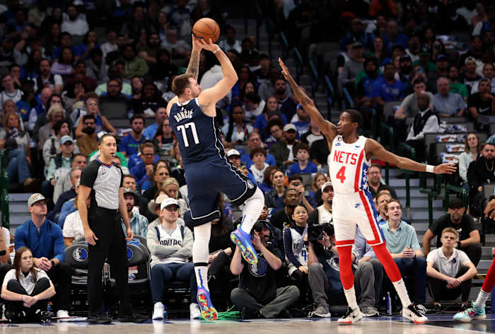 Mavs' Luka Doncic shoots a fadeaway jump shot over Nets' Edmond Sumner.